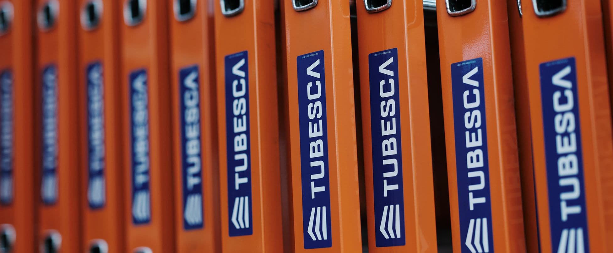 Multiple orange ladder segments with 'TUBESCA' logo displayed in a row.